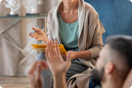 Gospa razlaga in v roki drži mapo